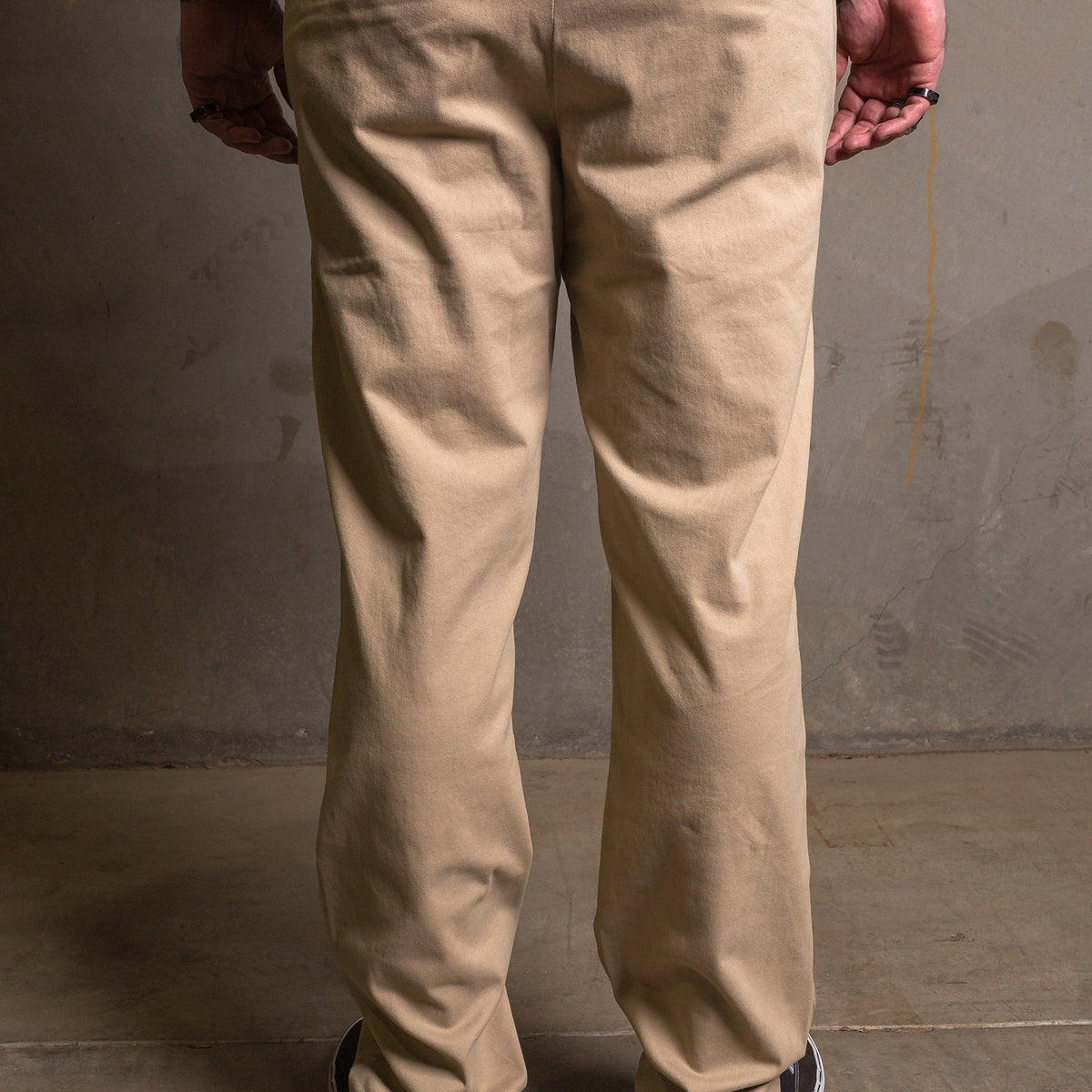 Dixxon Canada. Khaki Chino Pants. Side-back view displaying the slim fit, welt pockets, and the discreet stash pocket at the right hip.