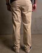 Dixxon Canada. Khaki Chino Pants. Side-back view displaying the slim fit, welt pockets, and the discreet stash pocket at the right hip.